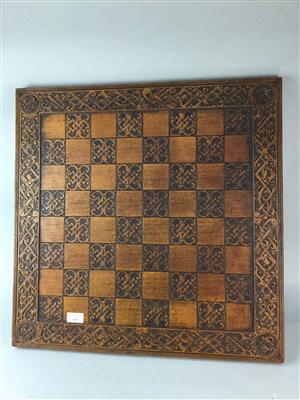 Lot 167 - A CHESS BOARD WITH CARVED DECORATION