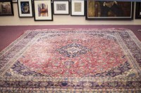 Lot 720 - KASHAN BORDERED CARPET decorate with a large...