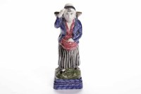 Lot 906 - SCOTTISH EAST COAST POTTERY FIGURE modelled as...