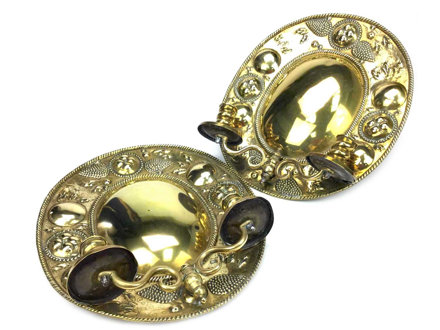 Lot 859 - A PAIR OF OVAL EMBOSSED BRASS WALL SCONCES