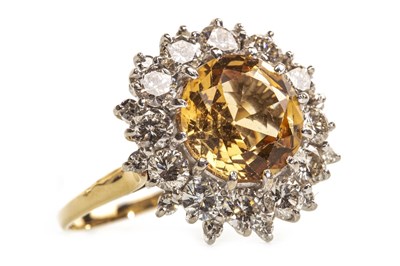 Lot 167 - A YELLOW TOPAZ AND DIAMOND RING
