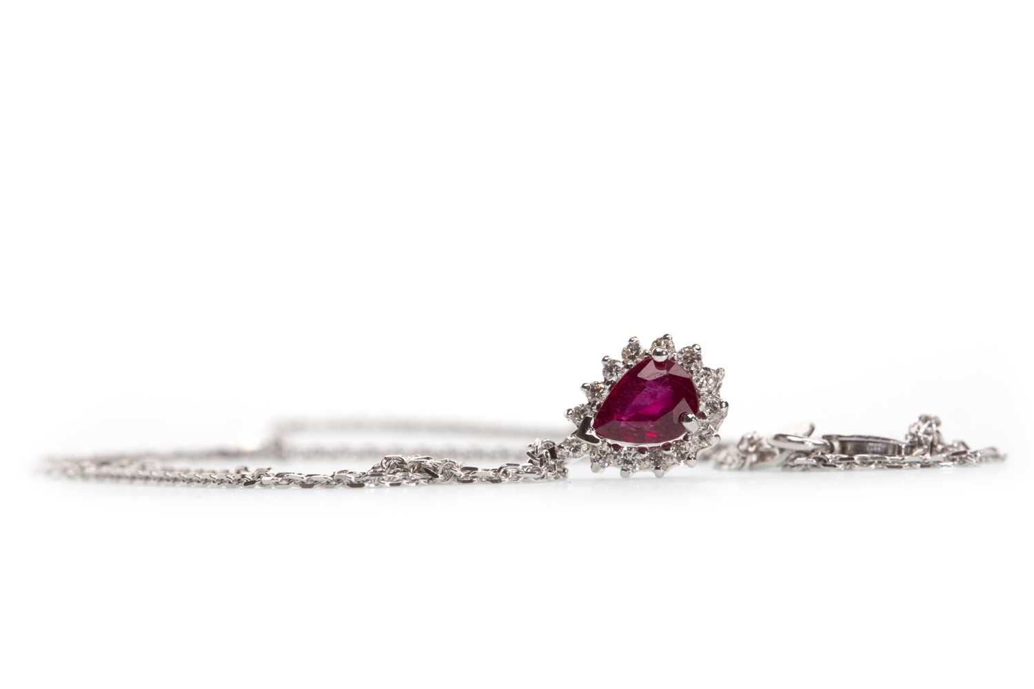 Lot 168 - A RUBY AND DIAMOND CLUSTER PENDANT