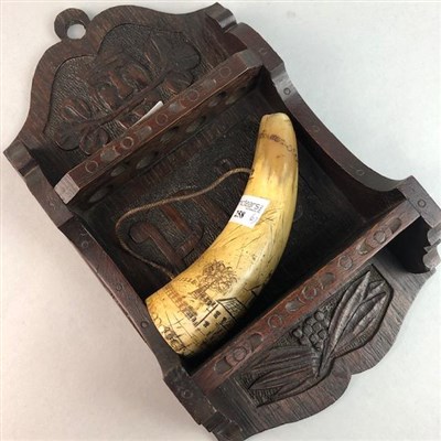 Lot 258 - A POWDER HORN AND AN ARTS & CRAFTS STYLE PIPE RACK