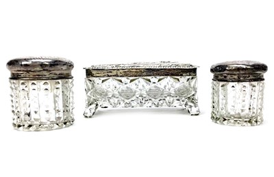 Lot 914 - A LOT OF THREE SILVER TOPPED DRESSING TABLE JARS
