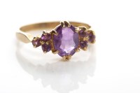 Lot 65 - AMETHYST SET DRESS RING c.1970s, the central...