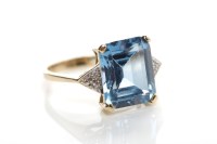 Lot 86 - TOPAZ AND DIAMOND RING the large emerald cut...