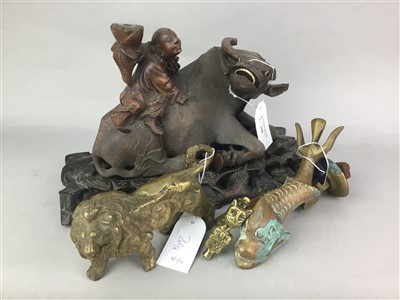 Lot 260 - AN ASIAN CARVED WOOD FIGURE OF A BULL AND RIDER