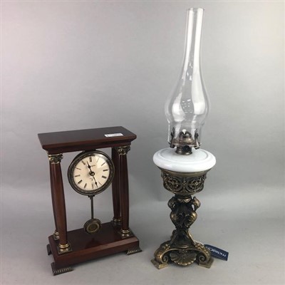 Lot 143 - A FRENCH STYLE MANTEL CLOCK AND AN OIL LAMP