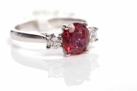 Lot 178 - RUBY AND DIAMOND THREE STONE RING the central...