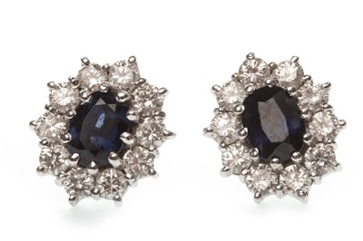 Lot 106 - A PAIR OF BLUE GEM AND DIAMOND CLUSTER EARRINGS