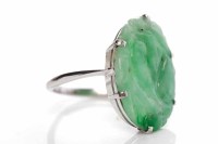 Lot 224 - TWENTIETH CENTURY CARVED JADE RING with a...