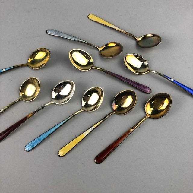 Lot 56 - A SET OF TEN SILVER AND ENAMEL COFFEE SPOONS