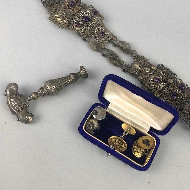 Lot 41 - A PIERCED WHITE METAL BELT, BADGES, COINS AND COSTUME JEWELLERY
