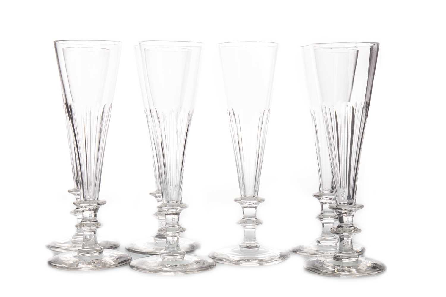 Lot 1285 - A SET OF SEVEN 19TH CENTURY GLASS WINE FLUTES