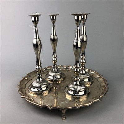 Lot 300 - A SET OF FOUR PLATED CANDLESTICKS AND A SALVER