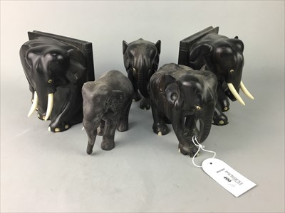 Lot 400 - A PAIR OF EBONY ELEPHANT BOOKENDS AND THREE CARVED FIGURES OF ELEPHANTS