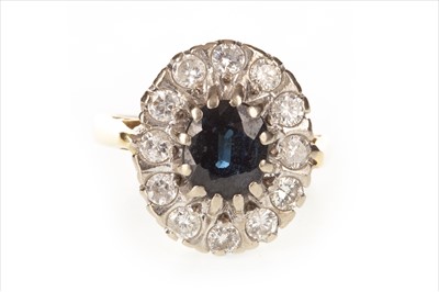 Lot 372 - AN OVAL BLUE GEM AND DIAMOND CLUSTER RING