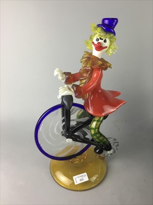 Lot 522 - A GLASS CLOWN ON A BICYCLE