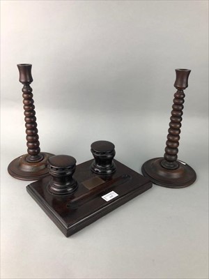 Lot 125 - A MAHOGANY INKSTAND AND PAIR OF TURNED WOODEN CANDLESTICKS