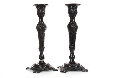 Lot 306 - A PAIR OF LACQUERED AND CAST METAL CANDLESTICKS