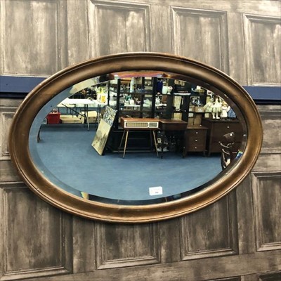 Lot 354 - AN OVAL BEVELLED WALL MIRROR
