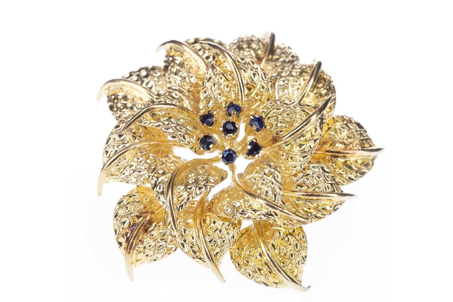 Lot 296 - A BLUE GEM SET FLOWER BROOCH