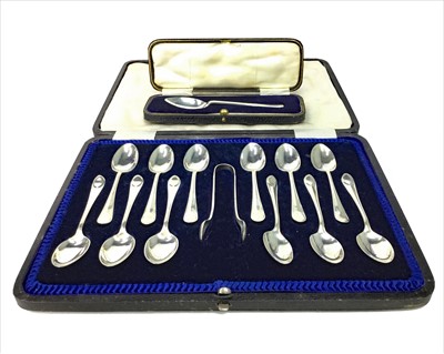 Lot 911 - A SET OF TWELVE GEORGE V SILVER TEASPOONS AND TONGS ALONG WITH ANOTHER CASED SPOON