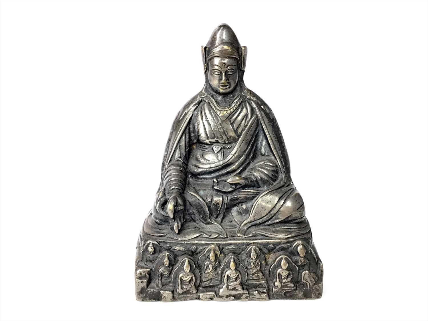 Lot 1165 - A TIBETAN/CHINESE WHITE METAL FIGURE OF A SEATED BUDDHA