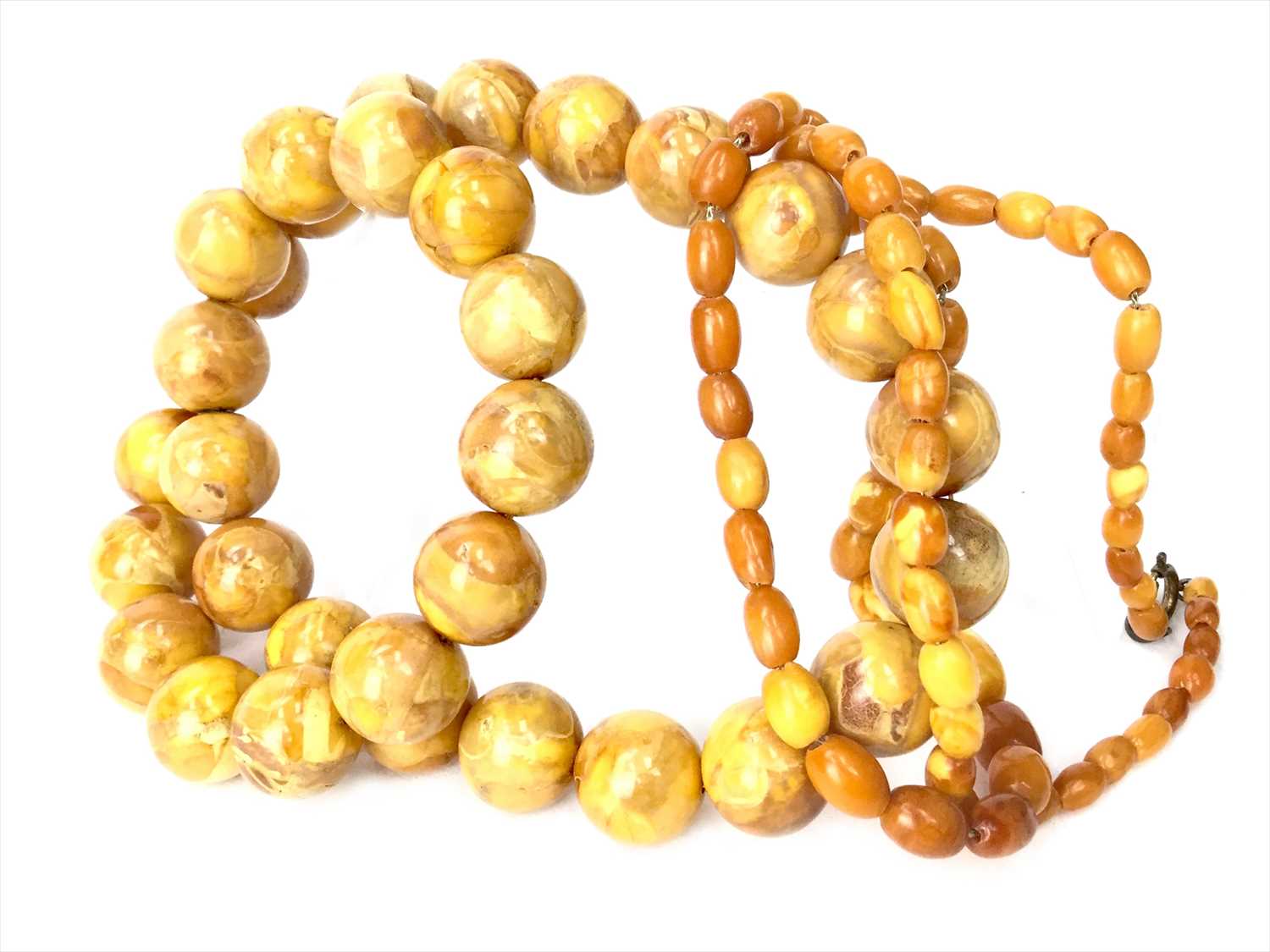 Lot 1167 - A LOT OF TWO AMBER BEAD NECKLACES