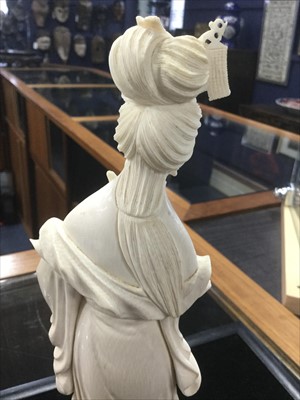 Lot 1197 - AN EARLY 20TH CENTURY CHINESE IVORY CARVING OF A FEMALE