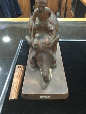Lot 1199 - A BURMESE CARVED TEAK MODEL OF AN ELEPHANT AND RIDER
