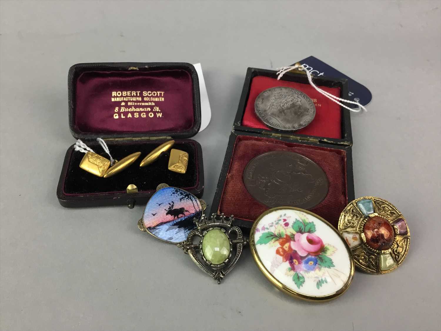 Lot 12 - A PAIR OF 15 CARAT GOLD CUFFLINKS ALONG WITH A SILVER CROWN, AGRICULTURAL MEDAL AND BROOCHES