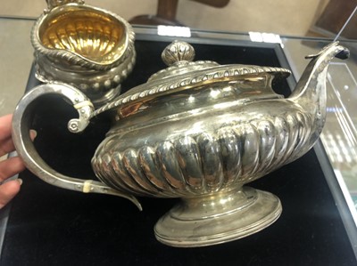 Lot 418 - A GEORGE III SILVER TEAPOT AND CREAMER
