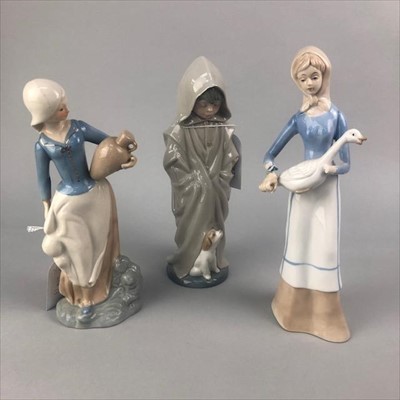 Lot 218 - A NAO FIGURE OF A BOY AND A PUPPY AND TWO CERAMIC FIGURES OF FEMALES