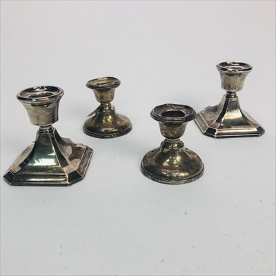 Lot 124 - A LOT OF TWO PAIRS OF SILVER DWARF CANDLESTICKS