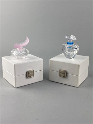 Lot 172 - A SWAROVSKI CRYSTAL BEAR TABLE CLOCK AND THREE SWAROVSKI CRYSTAL PERFUME BOTTLES