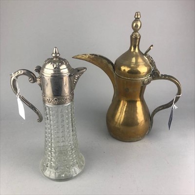 Lot 369 - AN EARLY 20TH CENTURY PERSIAN BRASS DALLAH AND A CLARET JUG