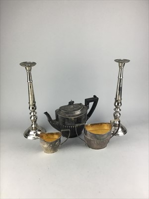 Lot 426 - A SILVER PLATED THREE PIECE TEA SERVICE, CANDLESTICKS, TROPHY AND OTHER ITEMS