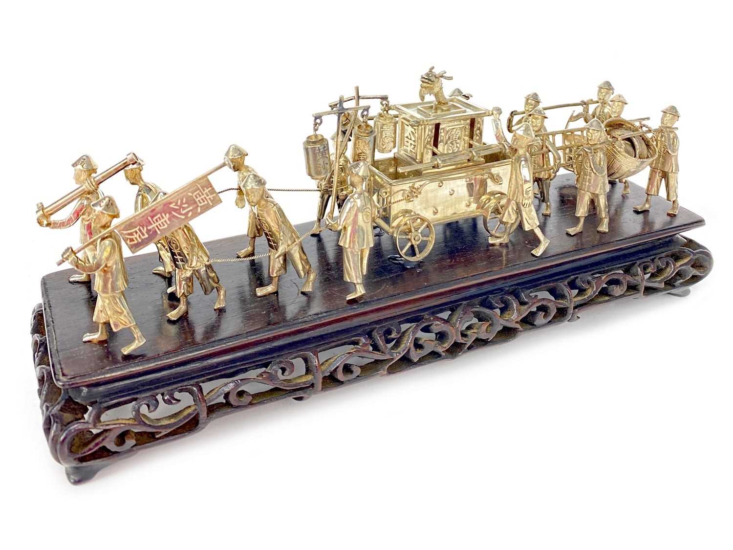 Lot 720 - A CHINESE WHITE METAL PROCESSIONAL FIGURE GROUP