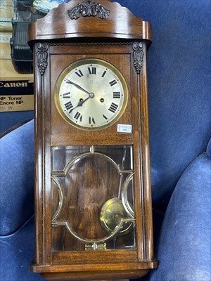 Lot 208 - A MODERN WALL CLOCK AND AN OVAL WALL MIRROR