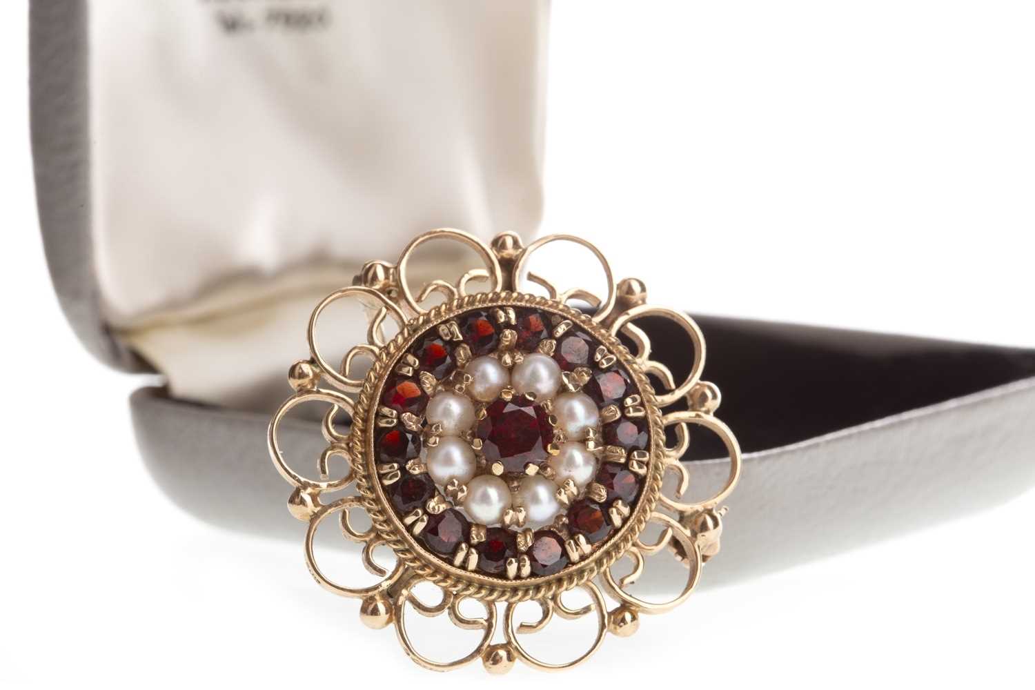 Lot 821 - A RED GEM SET AND SEED PEARL BROOCH