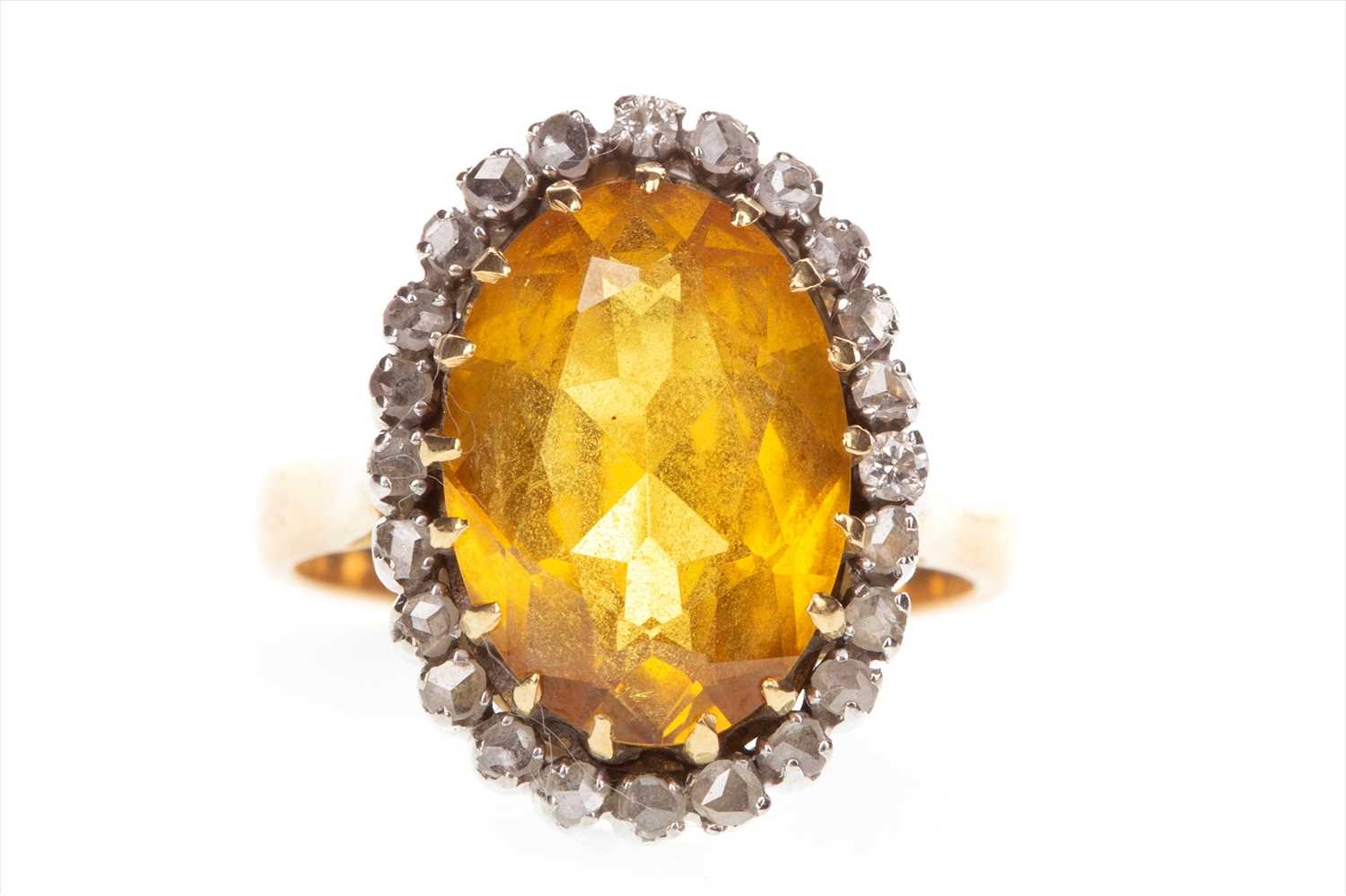 Lot 852 - A YELLOW GEM SET AND DIAMOND RING