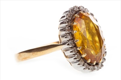 Lot 852 - A YELLOW GEM SET AND DIAMOND RING