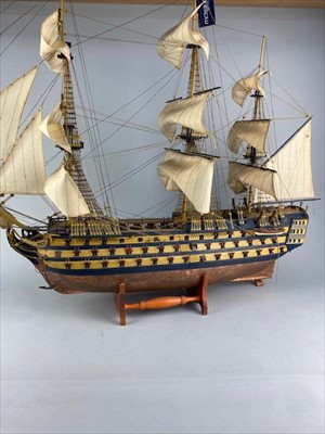 Lot 92 - A LARGE MODEL OF A BATTLESHIP ON A STAND