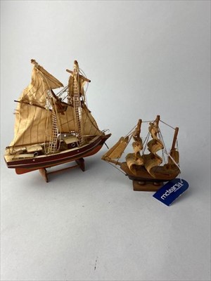 Lot 173 - A MODEL OF A BATTLESHIP, FOUR OTHER MODELS AND A SPITFIRE PAPERWEIGHT