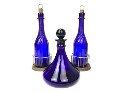 Lot 1029 - A PAIR OF WILLIAM IV BRISTOL BLUE GLASS DECANTERS AND A SHIPS DECANTER