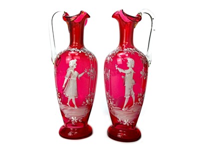 Lot 1030 - A PAIR OF VICTORIAN 'MARY GREGORY' STYLE CRANBERRY GLASS EWERS