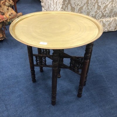 Lot 142 - A BRASS TOPPED COFFEE TABLE ON FOLDING STAND