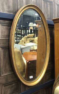 Lot 112 - AN OVAL BEVELLED WALL MIRROR