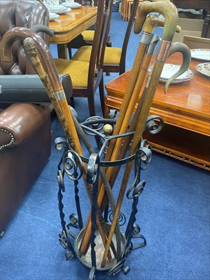 Lot 30 - A WROUGHT IRON STICK STAND AND VARIOUS WALKING STICKS